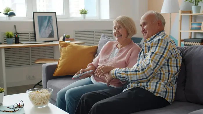 An older couple at ease on their sofa