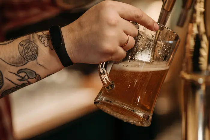 A fresh beer being poured at a tap