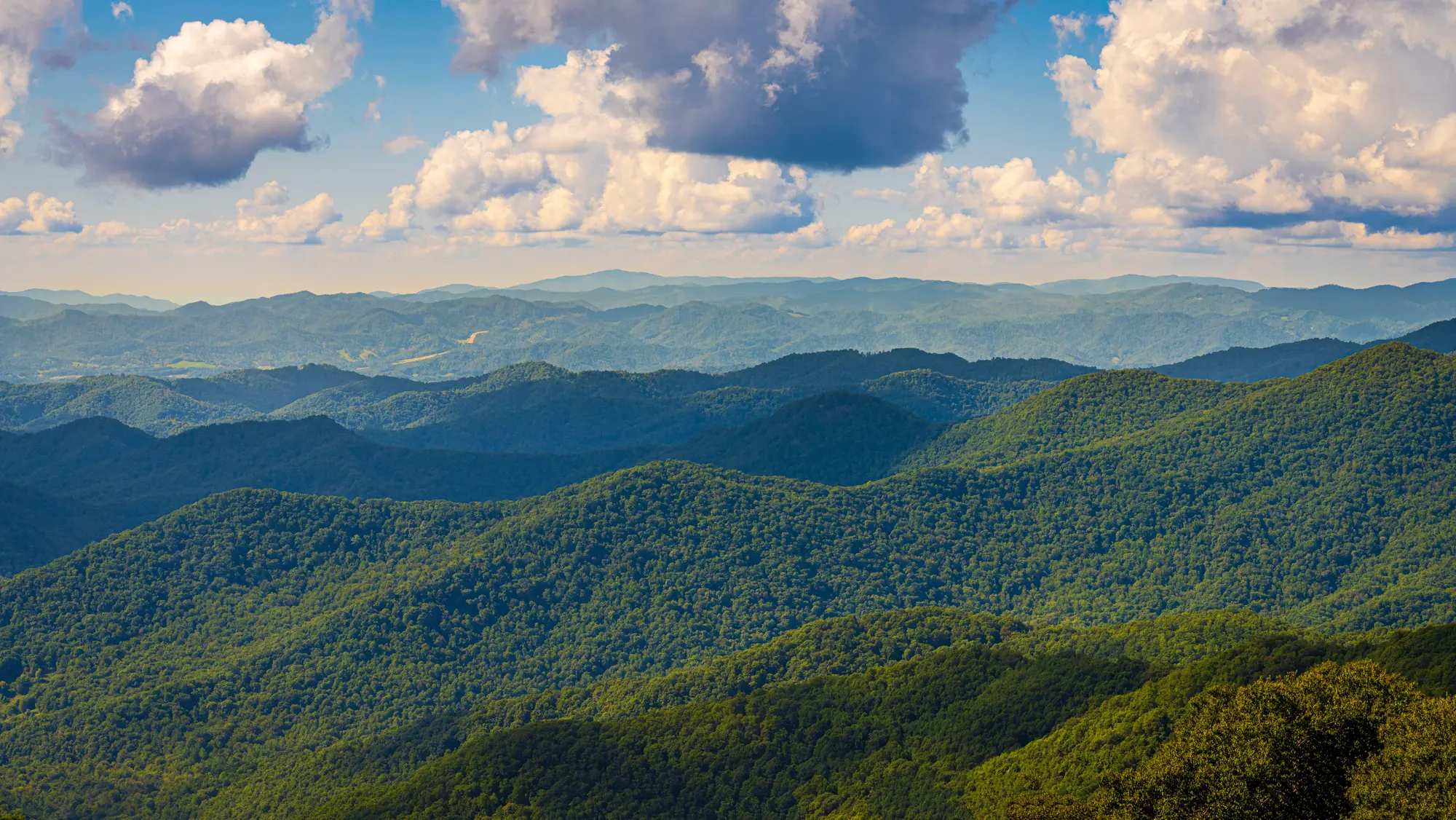 Green mountain ridges under a summer sky